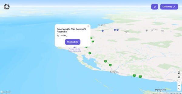 Interactive map from Vanlifezone featuring the coastal region of Western Australia with a focus on road travel. A pop-up window is displayed, promoting a journal article titled 'Freedom On The Roads Of Australia' by @75vibes_. The 'Read article' button within the pop-up links to the article in our journal online. The map shows key locations such as Port Hedland, Tom Price, and Monkey Mia, with a vast ocean backdrop. Navigation tools are present for user interaction, and the map credits Mapbox and OpenStreetMap in the corner.