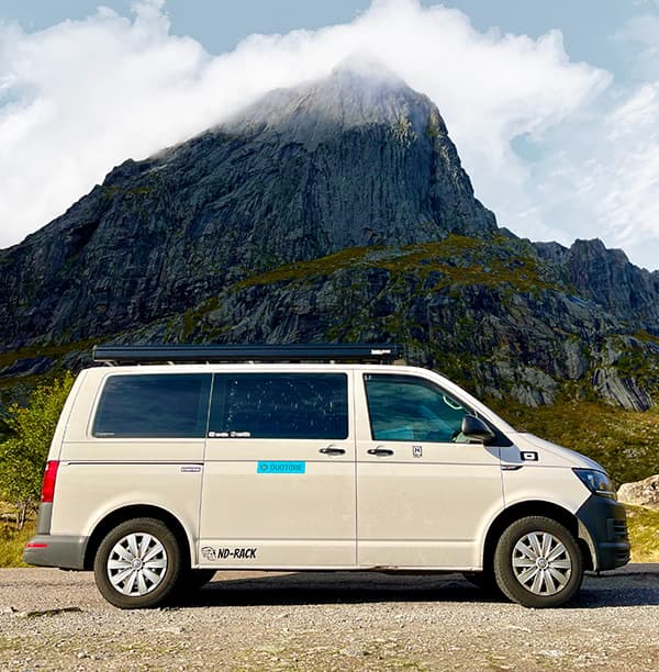 Columbus, a 2016 Volkswagen T6 Transporter - @van4life__ 10/2024 @van4life__'s self-converted VW T6 campervan parked in front of a dramatic mountain landscape in Norway, showcasing the vehicle used for his Scandinavian vanlife road trip.